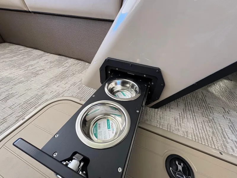 Slide: The Image of 2025 Crest Classic 220 pontoon boat on trailer in showroom setting. - 9