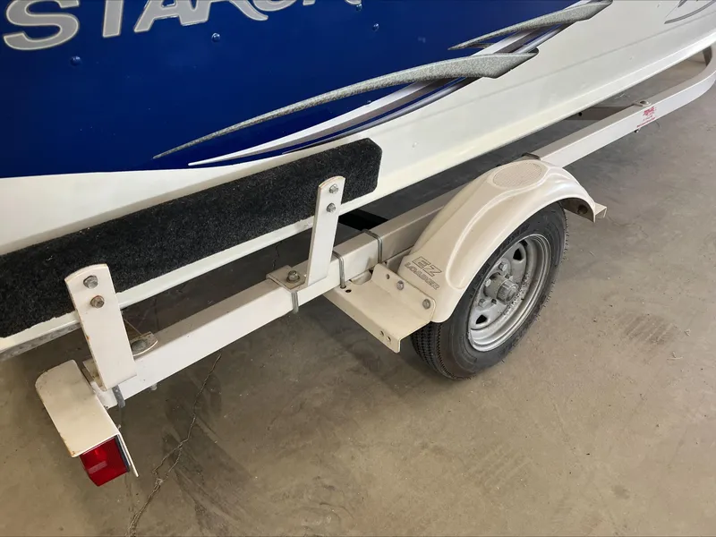 Slide: The Image of 2005 Starcraft Wb 16 D-Star boat trailer, partial view with wheel and fender. - 10