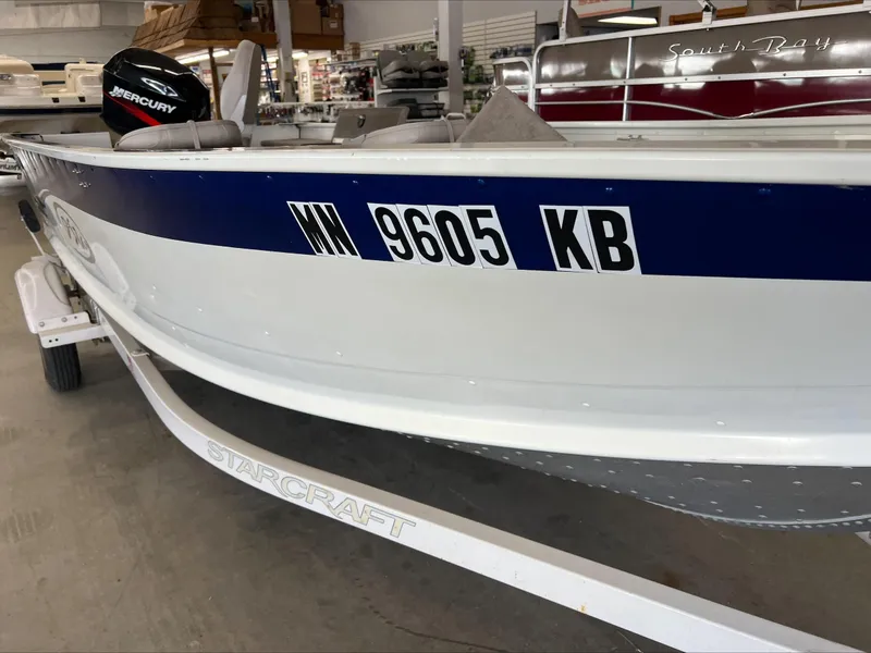 Slide: The Image of 2005 Starcraft Wb 16 D-Star boat with registration number WI 9605 KB in a showroom. - 11