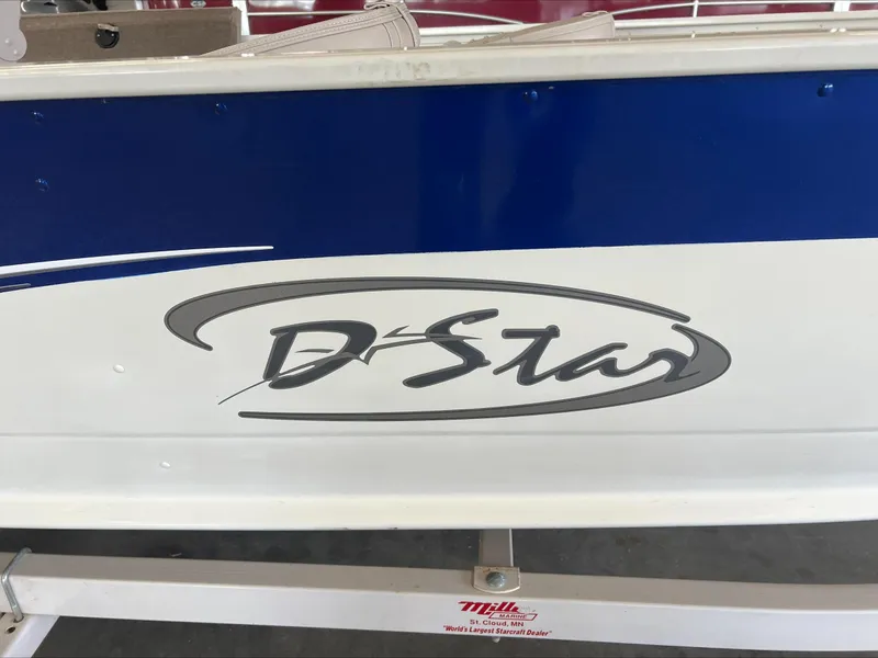 Slide: The Image of 2005 Starcraft Wb 16 D-Star boat with blue and white exterior design. - 12
