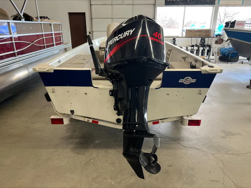 Slide: The Image of 2005 Starcraft Wb 16 D-Star boat with Mercury 40 outboard motor in a garage. - 3