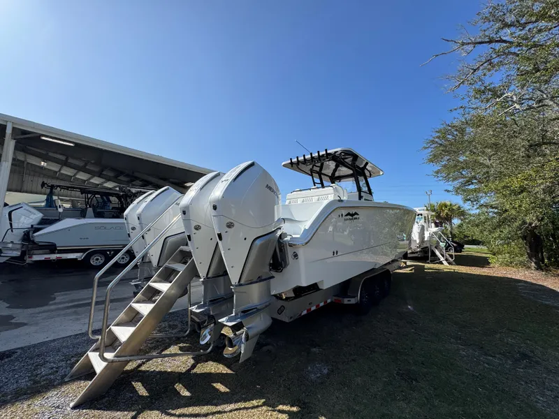 Slide: The Image of 2025 Invincible 38 Catamaran with dual engines, parked outdoors under clear blue sky. - 11