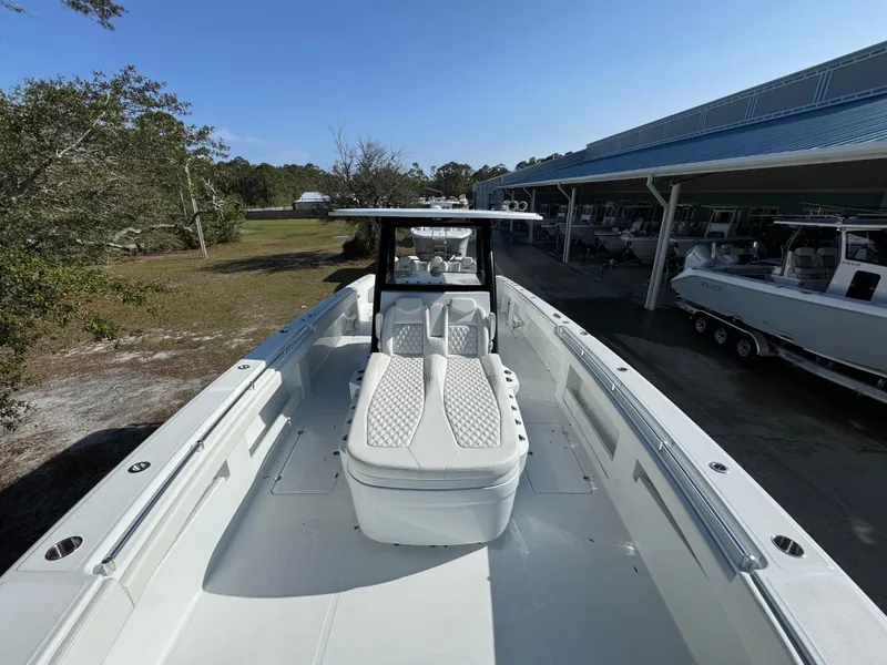 Slide: The Image of 2025 Invincible 38 Catamaran with sleek design and spacious deck, docked outdoors. - 16