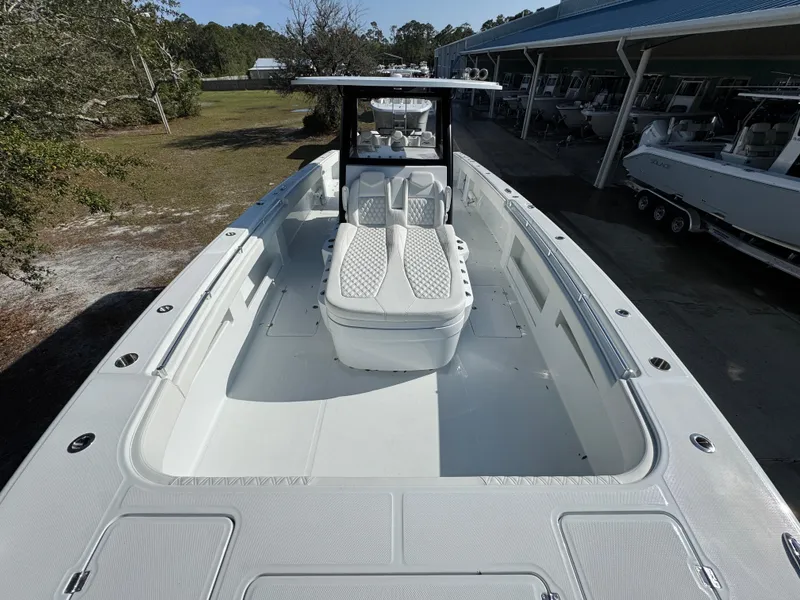 Slide: The Image of 2025 Invincible 38 Catamaran with sleek design and spacious deck, docked outdoors. - 18