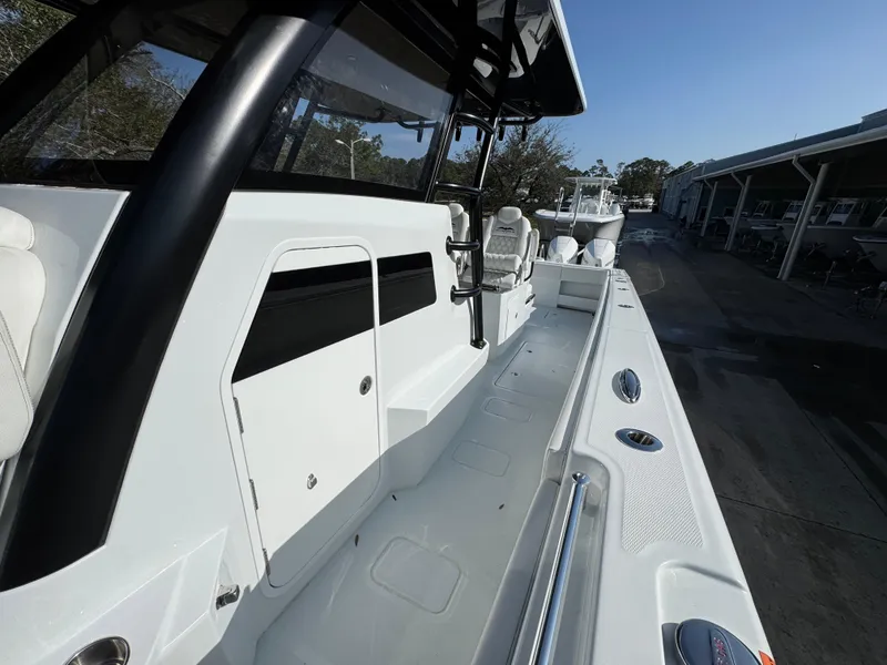 Slide: The Image of 2025 Invincible 38 Catamaran, sleek white deck, modern design, spacious layout, outdoor setting. - 21