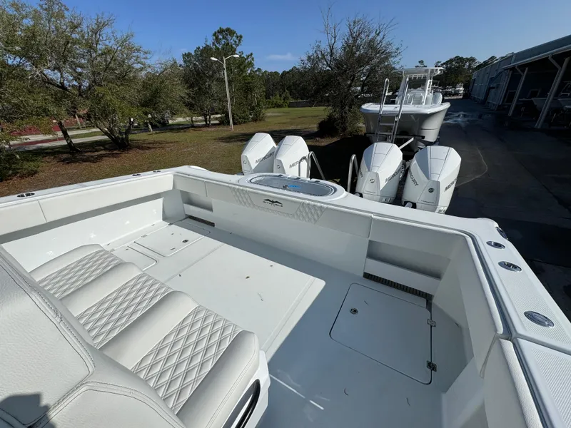 Slide: The Image of 2025 Invincible 38 Catamaran with triple outboard engines, spacious deck, and luxurious seating. - 29