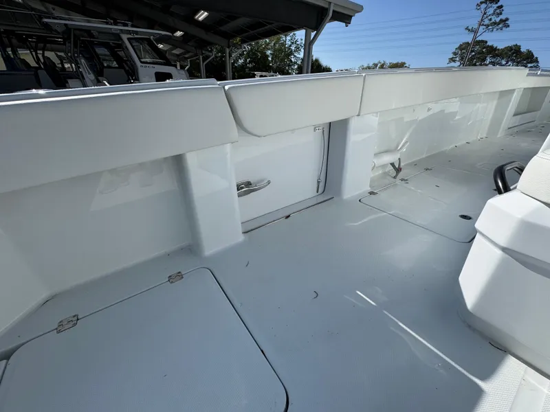 Slide: The Image of 2025 Invincible 38 Catamaran deck, showcasing spacious and sleek design under a sunny sky. - 30