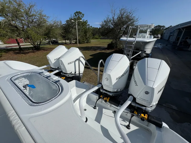 Slide: The Image of 2025 Invincible 38 Catamaran with four Mercury outboard engines, docked outdoors. - 32