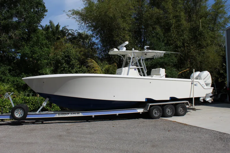 Slide: The Image of 2016 SeaVee 340Z boat on trailer, parked outdoors near trees. - 0