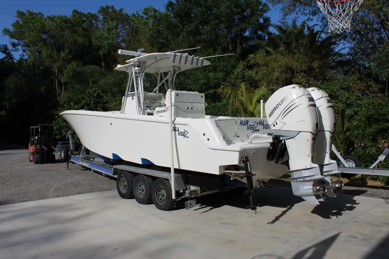 Slide: The Image of 2016 SeaVee 340Z boat on trailer with twin engines, parked outdoors. - 2