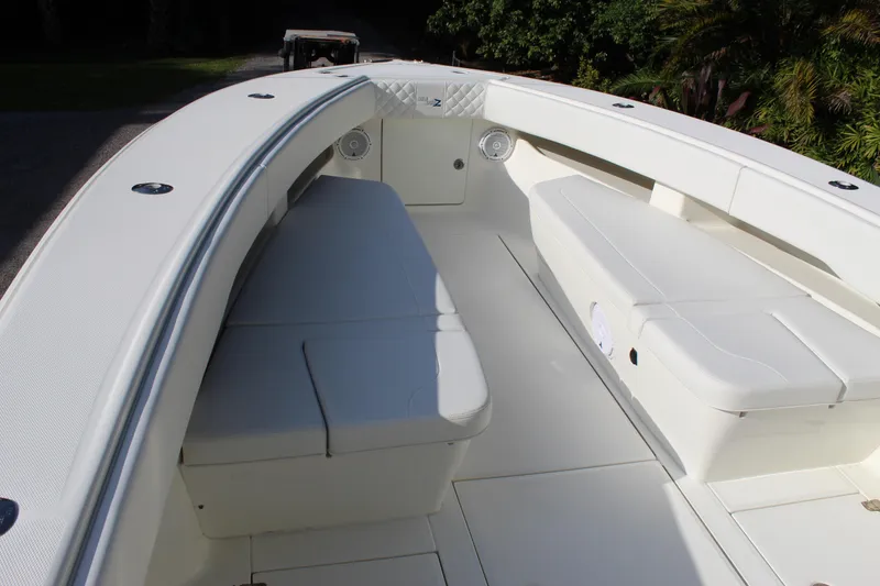 Slide: The Image of 2016 SeaVee 340Z boat interior with white seating and spacious deck. - 22