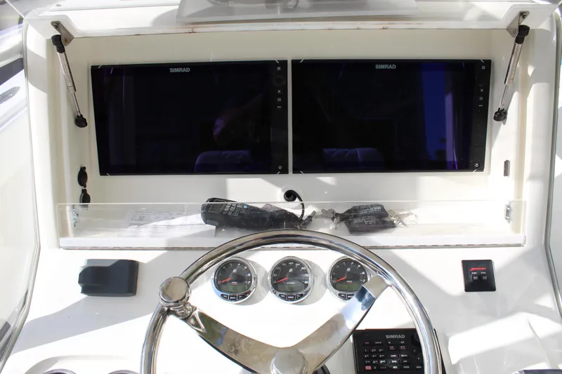 Slide: The Image of 2016 SeaVee 340Z helm with dual Simrad displays and stainless steel steering wheel. - 35