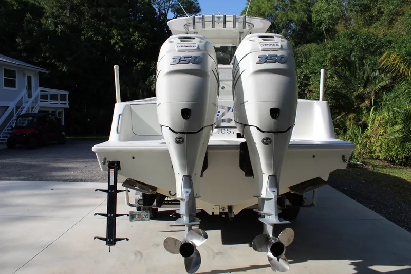 Slide: The Image of 2016 SeaVee 340Z boat with twin Yamaha 350 engines, parked on a driveway. - 4