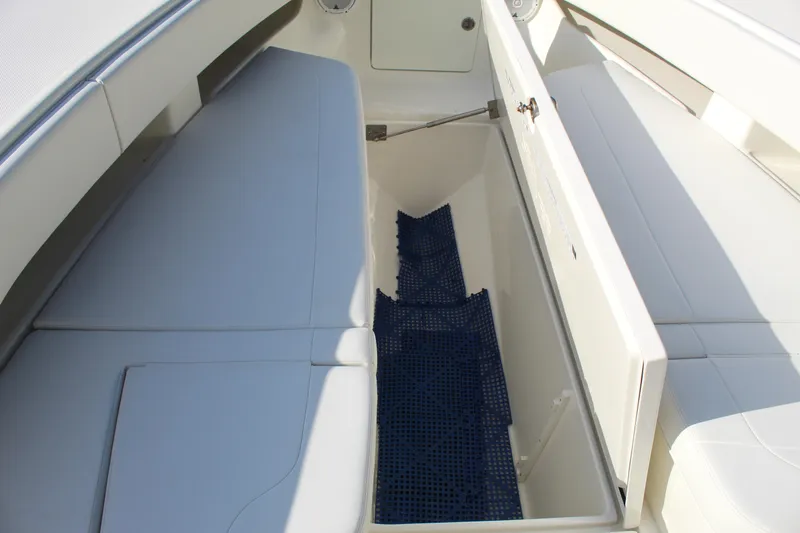 Slide: The Image of 2016 SeaVee 340Z boat storage compartment with cushioned seating and blue mat. - 43