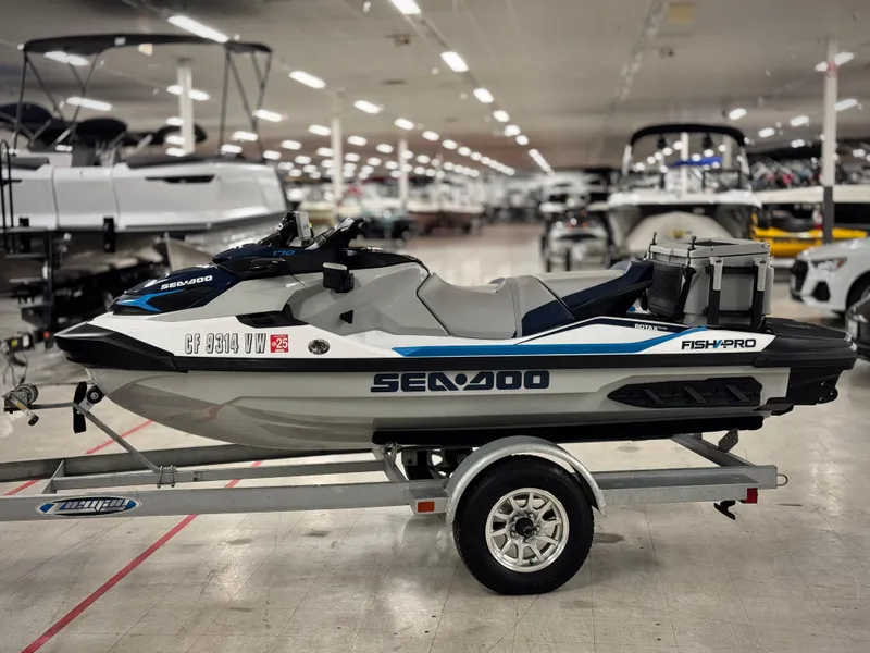 Slide: The Image of 2023 Sea-Doo Fishpro Sport 170 on trailer in showroom setting. - 2