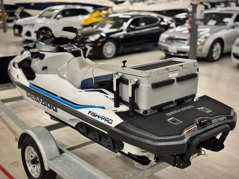 Slide: The Image of 2023 Sea-Doo Fishpro Sport 170 on trailer, displayed indoors with cars in the background. - 4