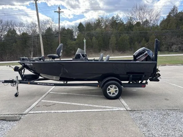 Slide: The Image of 2016 Ranger VS1680 boat on trailer, parked outdoors, with Mercury outboard motor. - 9