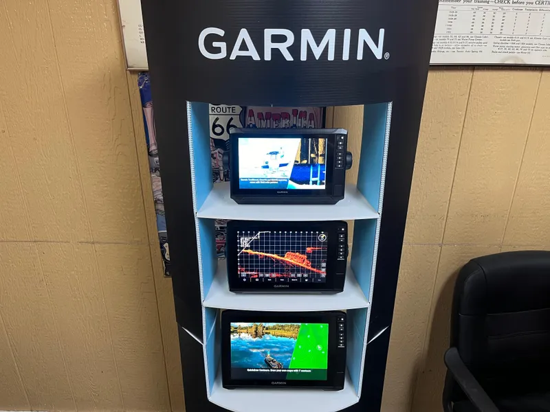 Slide: The Image of Garmin display with three marine GPS units, showcasing navigation and sonar features. - 1