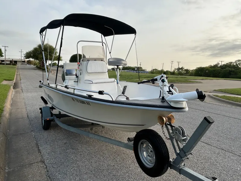 Slide: The Image of 2006 Carolina Skiff SEA CHASER boat on trailer with canopy, parked on roadside. - 10