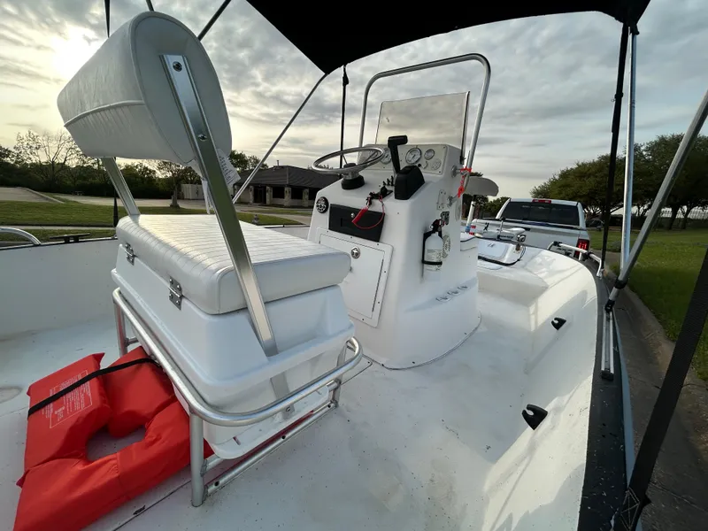 Slide: The Image of 2006 Carolina Skiff SEA CHASER boat interior with seating, console, and life jackets. - 13