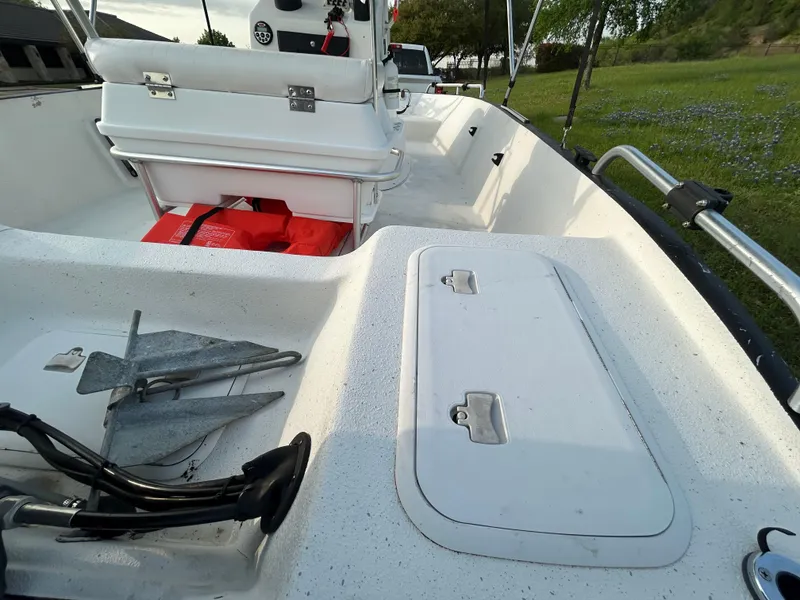 Slide: The Image of 2006 Carolina Skiff SEA CHASER boat interior with storage compartments and anchor. - 14