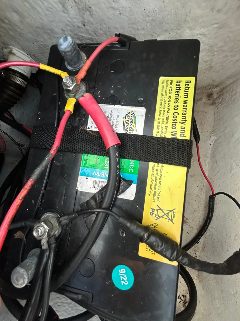 Slide: The Image of Battery setup in a 2006 Carolina Skiff SEA CHASER boat, featuring connected cables. - 15