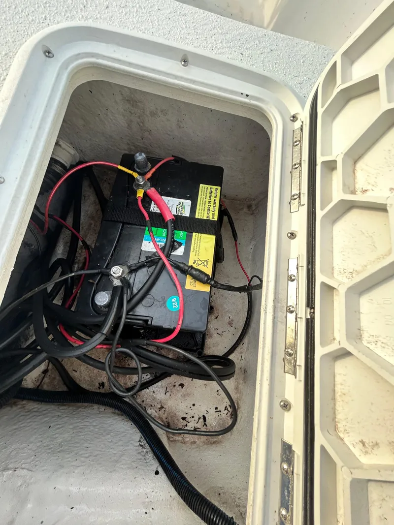 Slide: The Image of Battery compartment of a 2006 Carolina Skiff SEA CHASER boat, showing wiring and connections. - 16