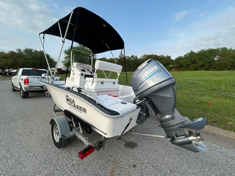 Slide: The Image of 2006 Carolina Skiff SEA CHASER boat with Yamaha motor on trailer, parked outdoors. - 18