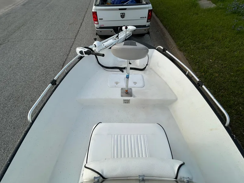 Slide: The Image of 2006 Carolina Skiff SEA CHASER boat interior with seating, parked near a white truck. - 19