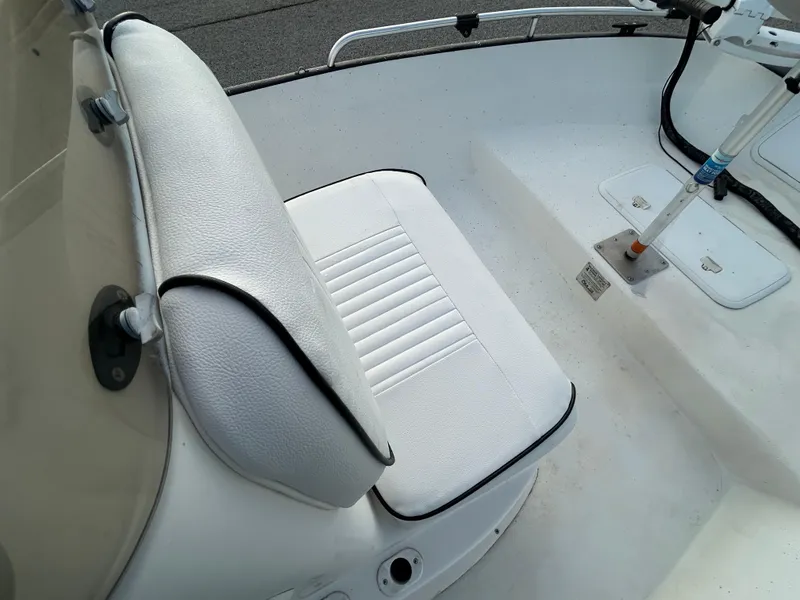 Slide: The Image of 2006 Carolina Skiff SEA CHASER boat seat with white upholstery and black trim. - 20