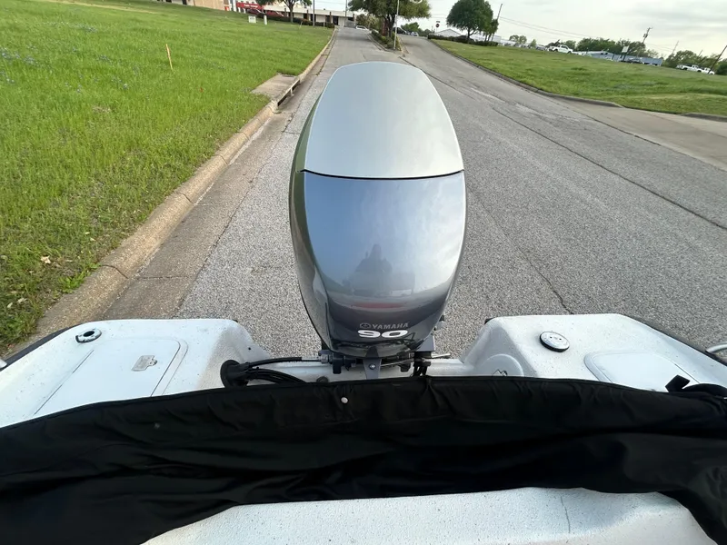 Slide: The Image of 2006 Carolina Skiff SEA CHASER with Yamaha 90 outboard motor on a road. - 24