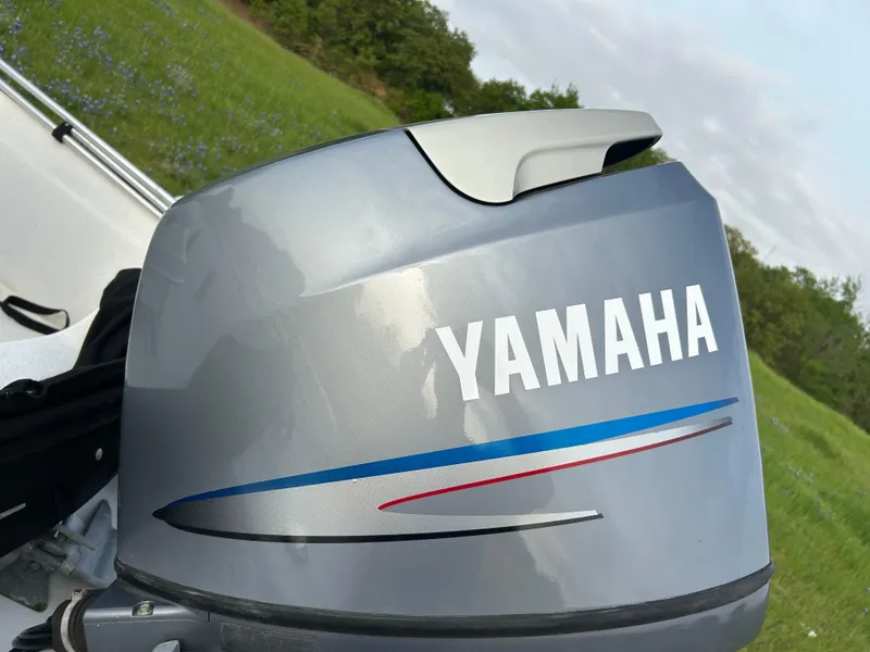 Slide: The Image of Yamaha outboard motor on 2006 Carolina Skiff SEA CHASER, set against a grassy background. - 26
