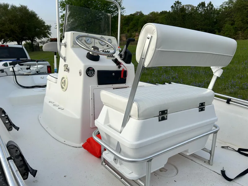 Slide: The Image of 2006 Carolina Skiff SEA CHASER boat interior with white seating and control panel. - 28