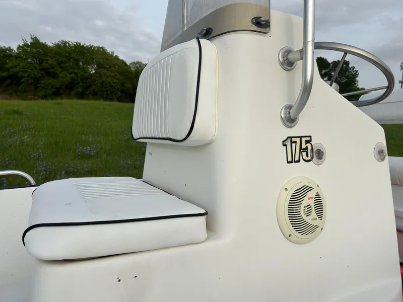 Slide: The Image of 2006 Carolina Skiff SEA CHASER boat console with seating and speaker, outdoors. - 30