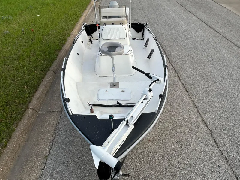 Slide: The Image of 2006 Carolina Skiff SEA CHASER boat on roadside, featuring a sleek white design. - 38