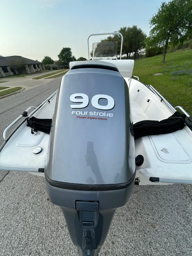 Slide: The Image of 2006 Carolina Skiff SEA CHASER with 90HP four-stroke engine, parked on a residential street. - 48