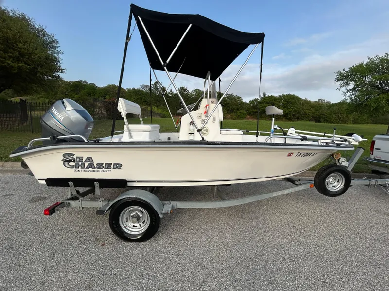 Slide: The Image of 2006 Carolina Skiff SEA CHASER boat on trailer with canopy, parked outdoors. - 5