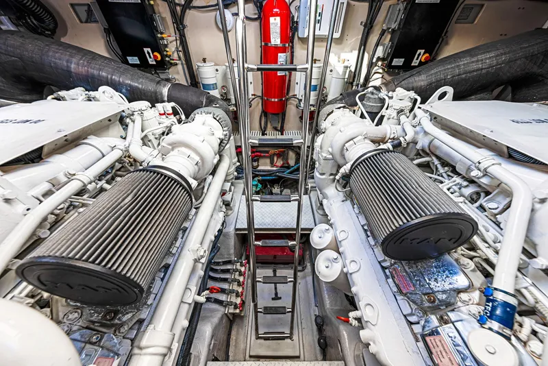 Slide: The Image of Engine room of 2009 Sea Ray 55 Sundancer yacht, featuring dual engines and fire extinguisher. - 31