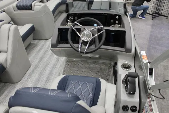 Slide: The Image of 2025 Bennington RX Sport Swingback 25 RXSB boat interior with modern steering console and seating. - 6