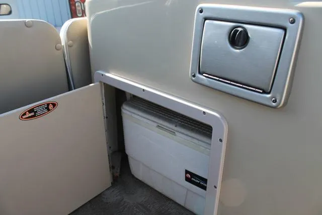 Slide: The Image of Storage compartment on a 2011 Harris 250 SL Grand Mariner boat with cooler inside. - 10