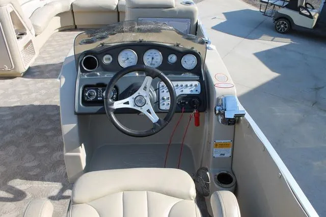 Slide: The Image of 2011 Harris 250 SL Grand Mariner boat dashboard with steering wheel and gauges. - 14