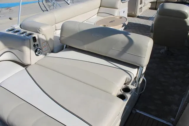 Slide: The Image of 2011 Harris 250 SL Grand Mariner boat interior with beige seating and cup holders. - 17