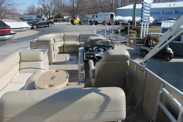 Slide: The Image of 2011 Harris 250 SL Grand Mariner pontoon boat interior with beige seating and steering console. - 20