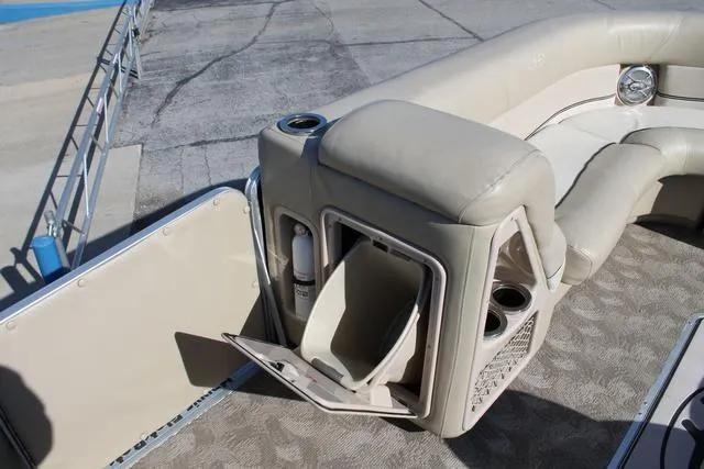 Slide: The Image of 2011 Harris 250 SL Grand Mariner boat interior with beige seating and storage compartment. - 21