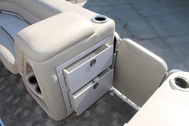 Slide: The Image of 2011 Harris 250 SL Grand Mariner boat interior with storage compartments and cup holders. - 22