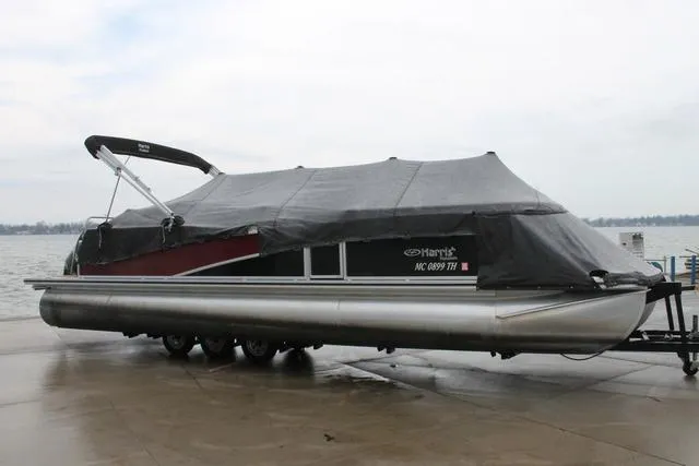 Slide: The Image of 2011 Harris 250 SL Grand Mariner pontoon boat covered, parked near a lake. - 5