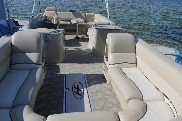 Slide: The Image of 2011 Harris 250 SL Grand Mariner pontoon boat with spacious seating on a calm lake. - 8