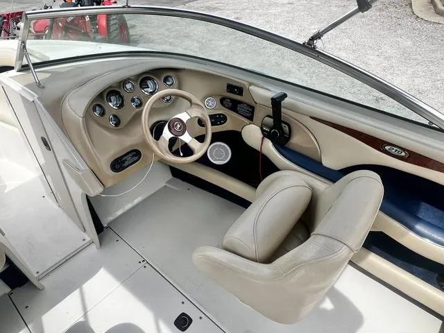 Slide: The Image of Interior of 2000 Sea Ray 210 Signature Bowrider, featuring steering wheel and dashboard controls. - 11