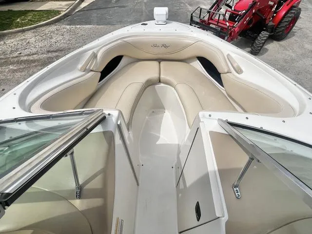 Slide: The Image of 2000 Sea Ray 210 Signature Bowrider boat with beige seating and open bow design. - 12
