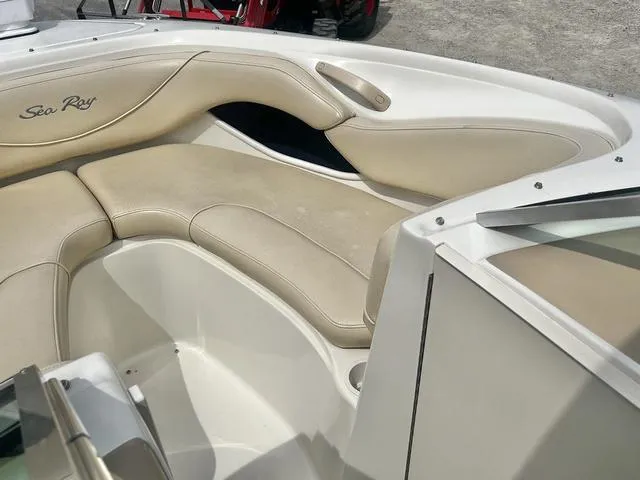 Slide: The Image of 2000 Sea Ray 210 Signature Bowrider interior with beige seating and sleek design. - 14